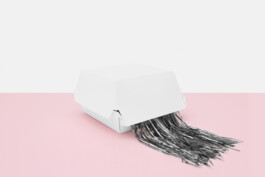 white hamburger packing with silver strings breaking out of it. 