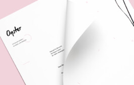 close-up of branded stationary lying on a pink background. 