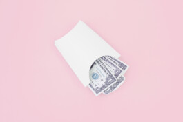 white french fries packaging with dollar bills inside. 