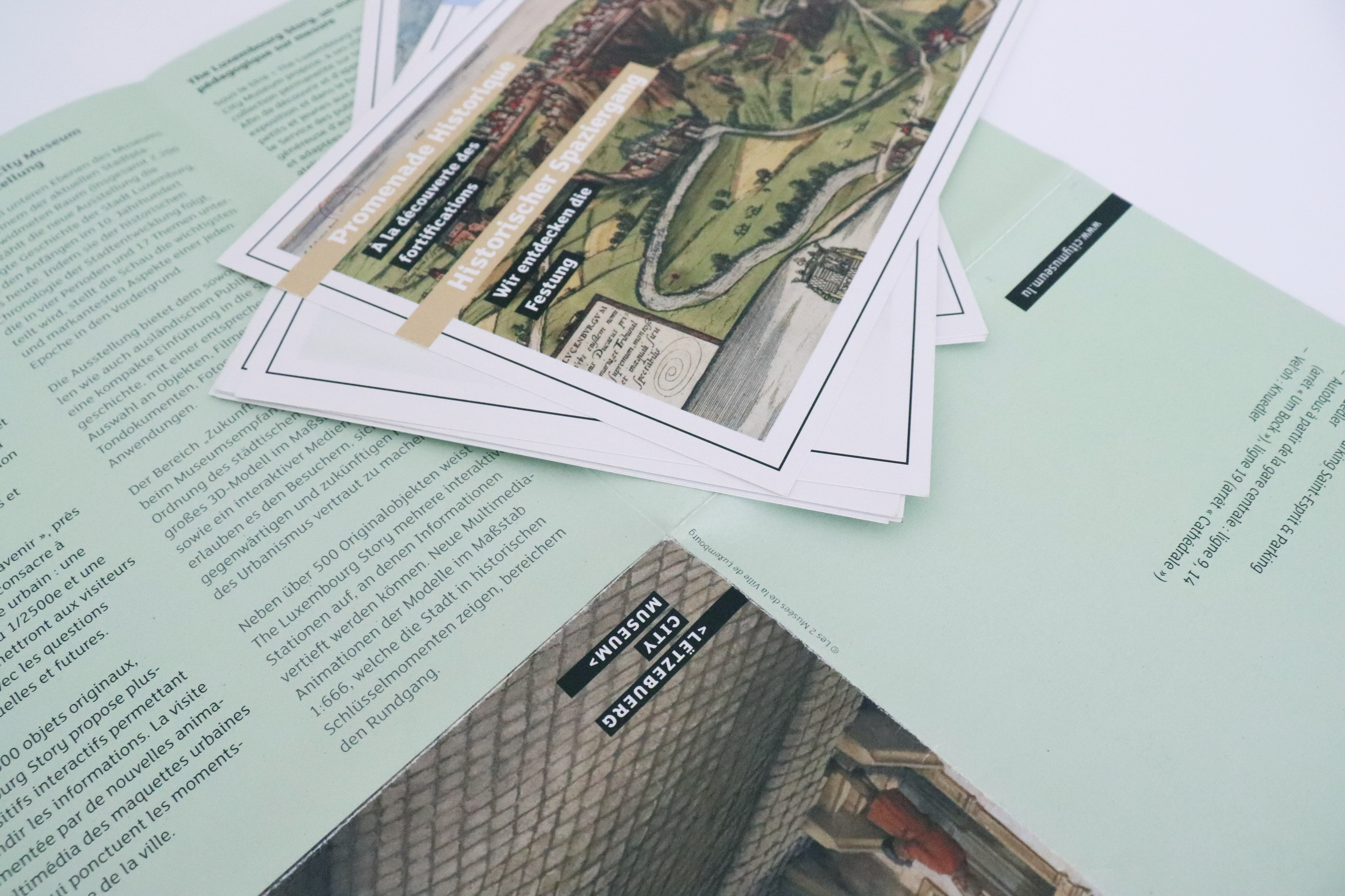 a pile of cards placed on the booklet cover that has been opened up.